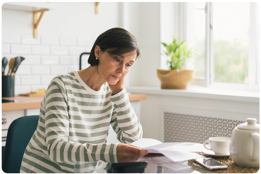 Woman looking worried at documents