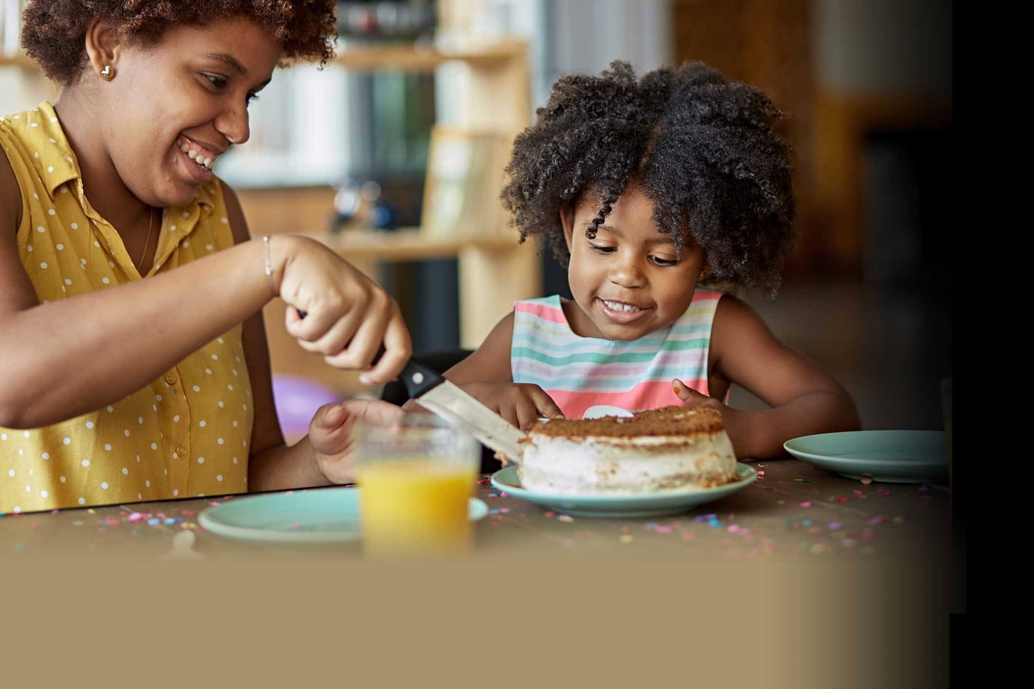 child with cake being cut