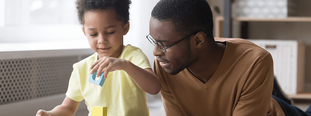 Man and son playing block building