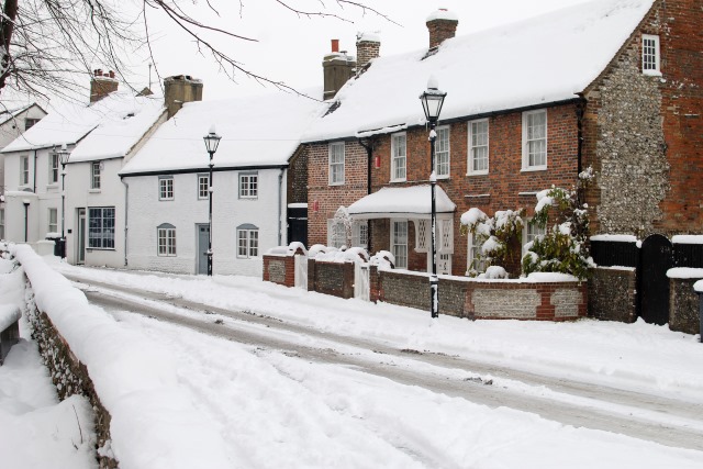 A residential street covered in snow 