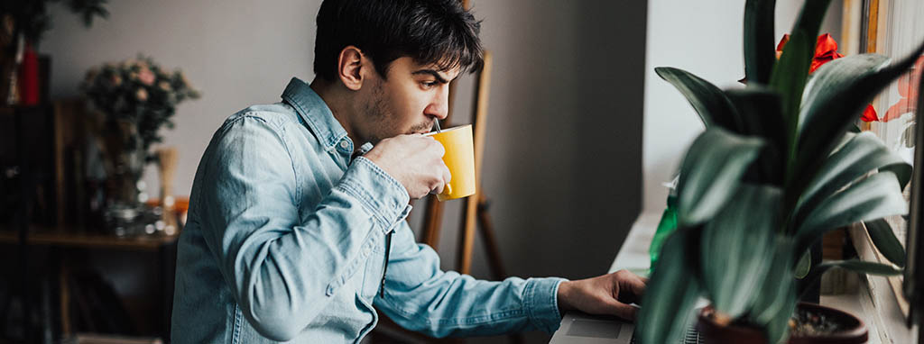 man drinking from mug