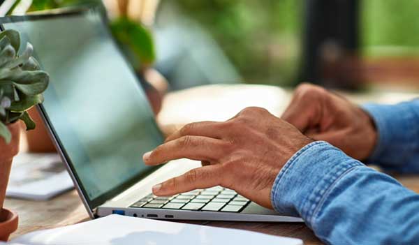 Man typing on keyboard