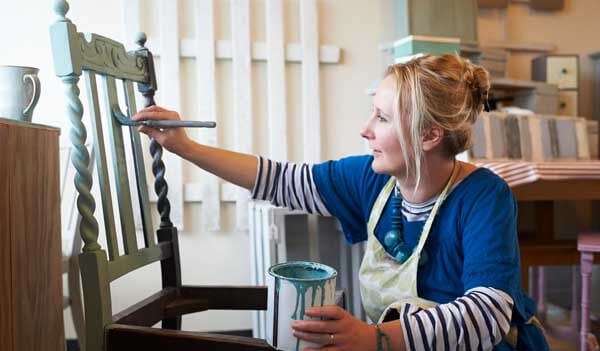 woman painting chair