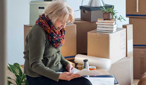 Woman reading with boxes