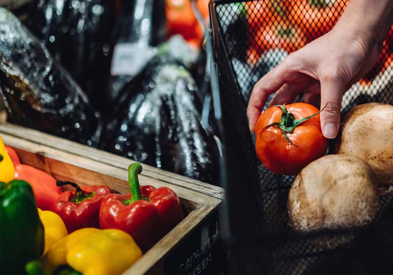 Hand picking up tomato