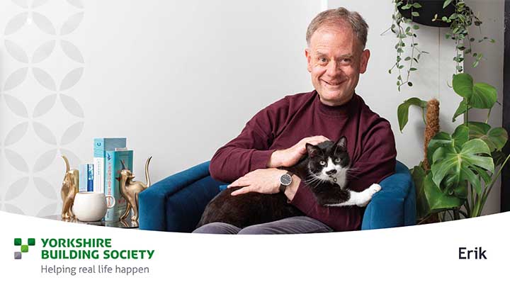 Man sitting in chair with cat