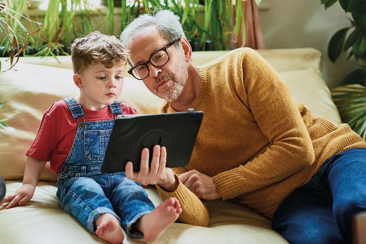 Grandfather and grandson looking at tablet