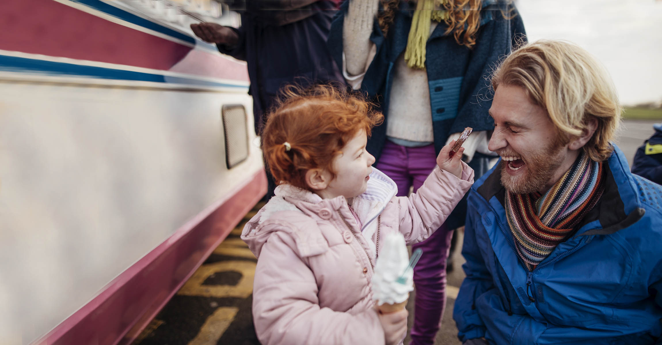 child with ice cream and man laughing