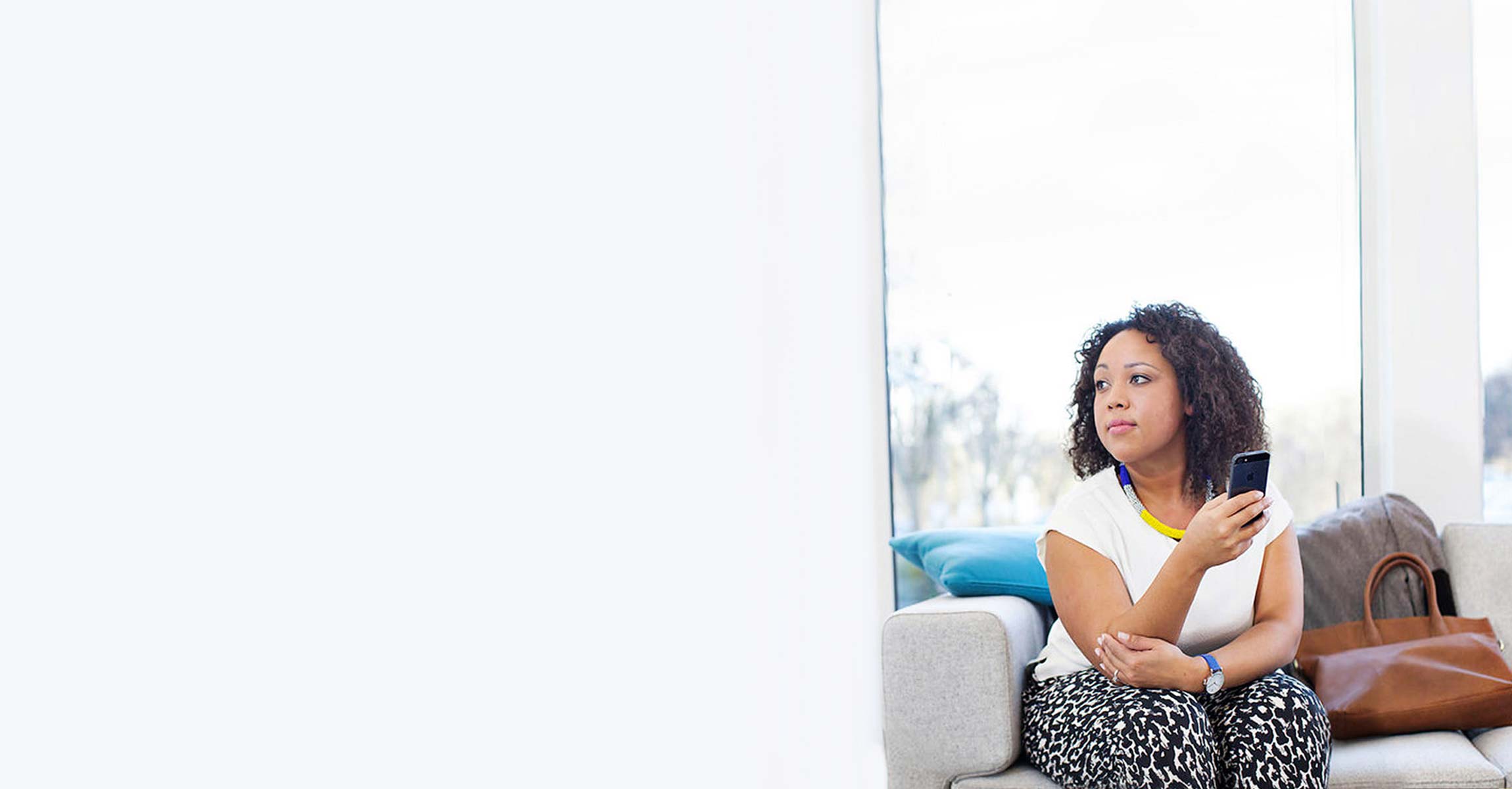 woman sitting using phone looking to the side